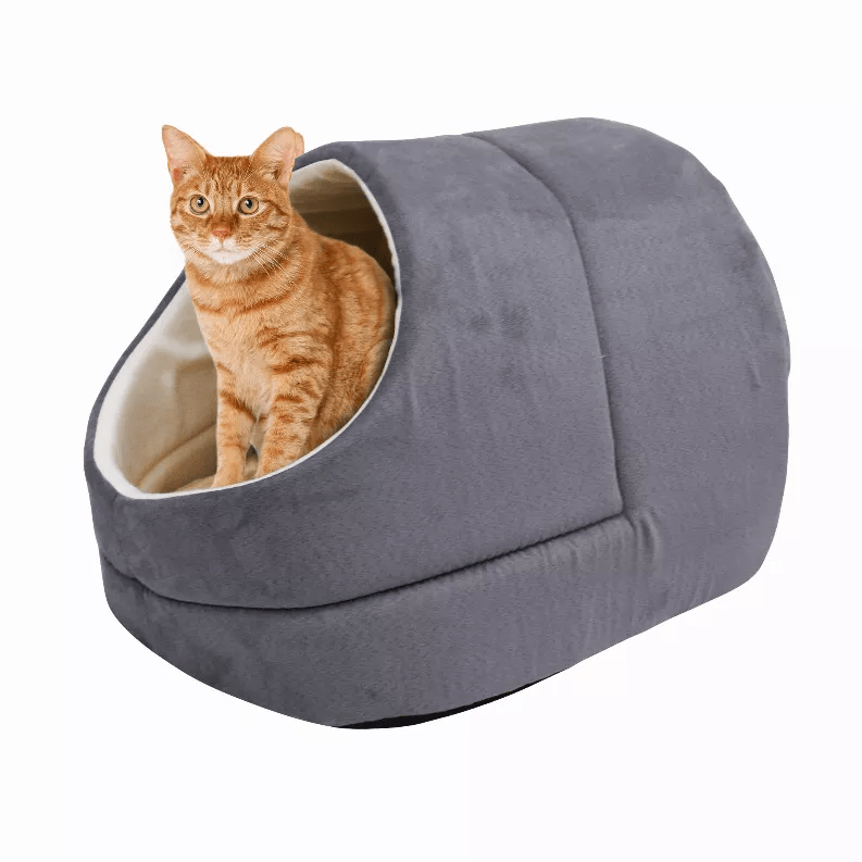 Orange tabby cat sitting inside a Pets Paradise Elite Warming Burrow Suede Cat Cave Bed.