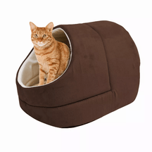 An orange tabby cat sitting inside a Pets Paradise Elite Warming Burrow Suede Cat Cave Bed.